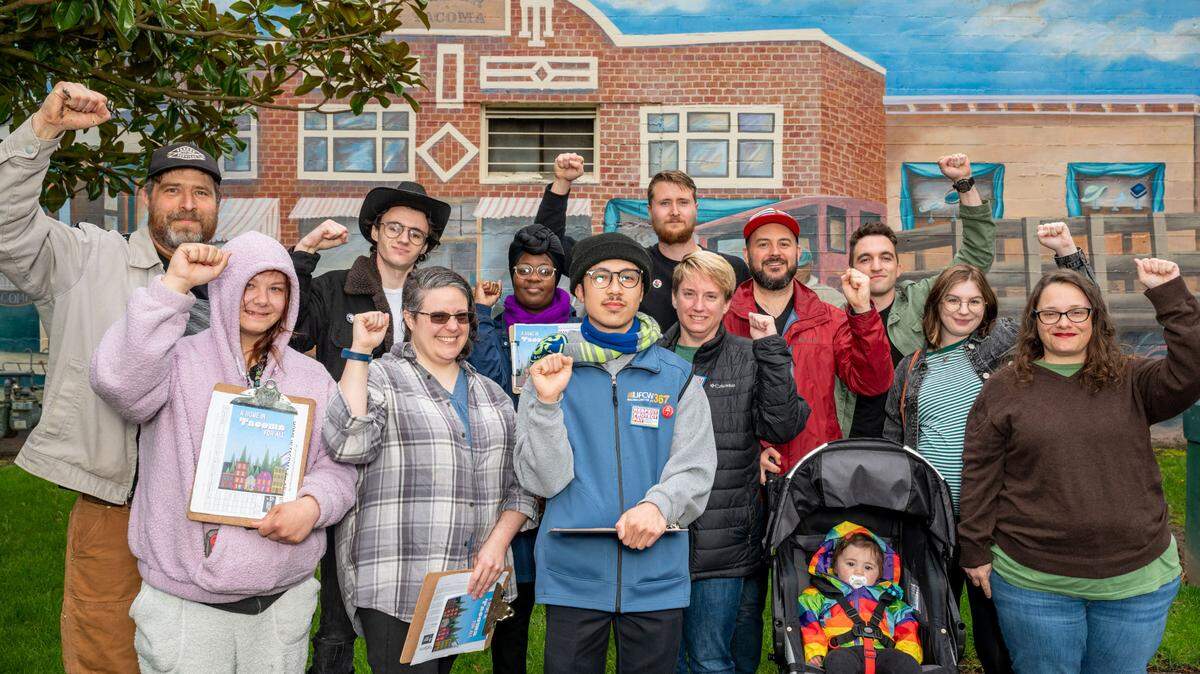 Members of the Tacoma For All campaign — a group that is fighting for affordable, sustainable and stable housing for Tacoma residents — pose for a portrait near a mural at People’s Park in the Hilltop neighborhood on Friday, May 6, 2022, in Tacoma, Wash.