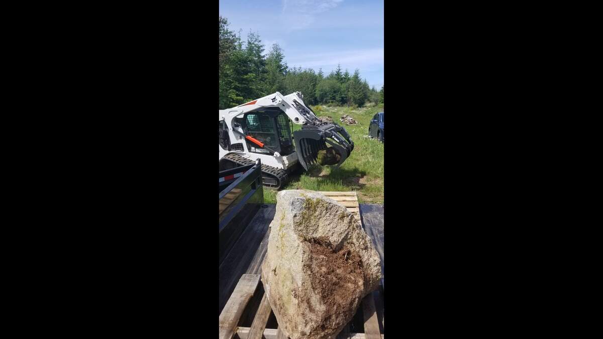 One of the items stolen from Barbara Henderson’s property on the Key Peninsula was a Bobcat Root grapple, pictured moving a large rock.