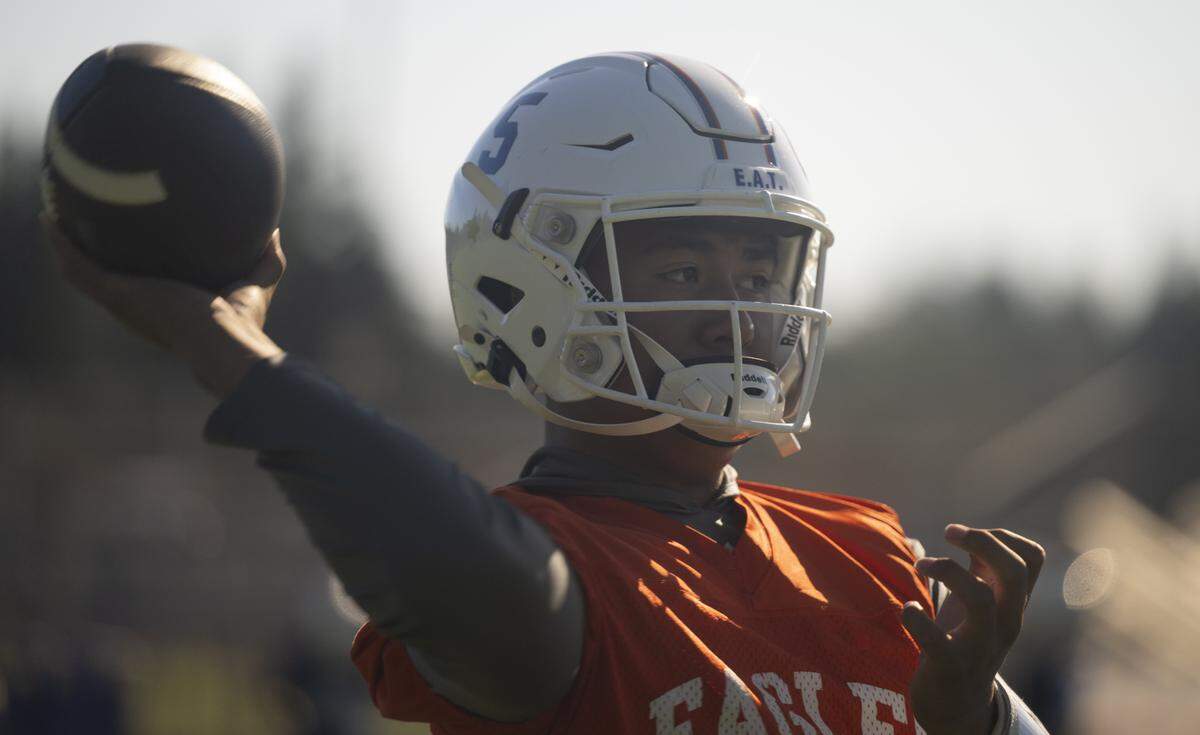 Graham-Kapowsin quarterback AJ Tuivaiave warms up during a football practice at Graham-Kapowsin High School on Friday, Aug. 22, 2025, in Graham.