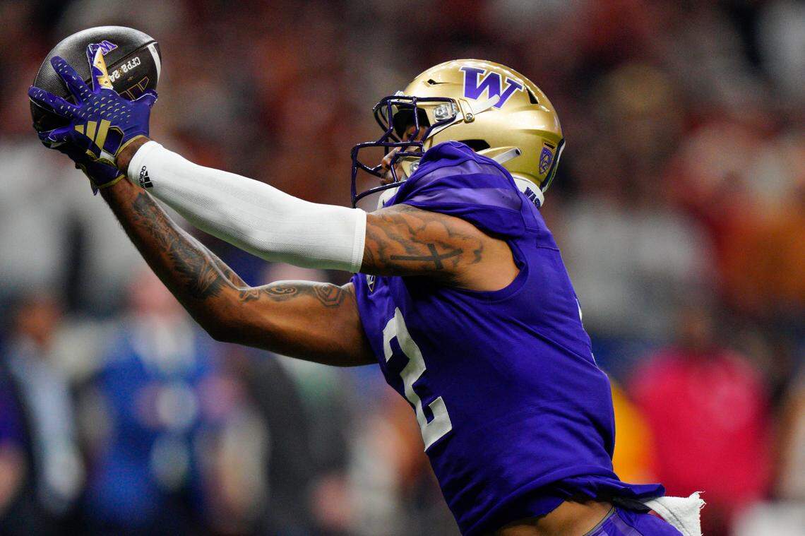 Washington wide receiver Ja’Lynn Polk (2) makes the catch for a touchdown against Texas during the first half of the Sugar Bowl CFP NCAA semifinal college football game, Monday, Jan. 1, 2024, in New Orleans. (AP Photo/Jacob Kupferman)