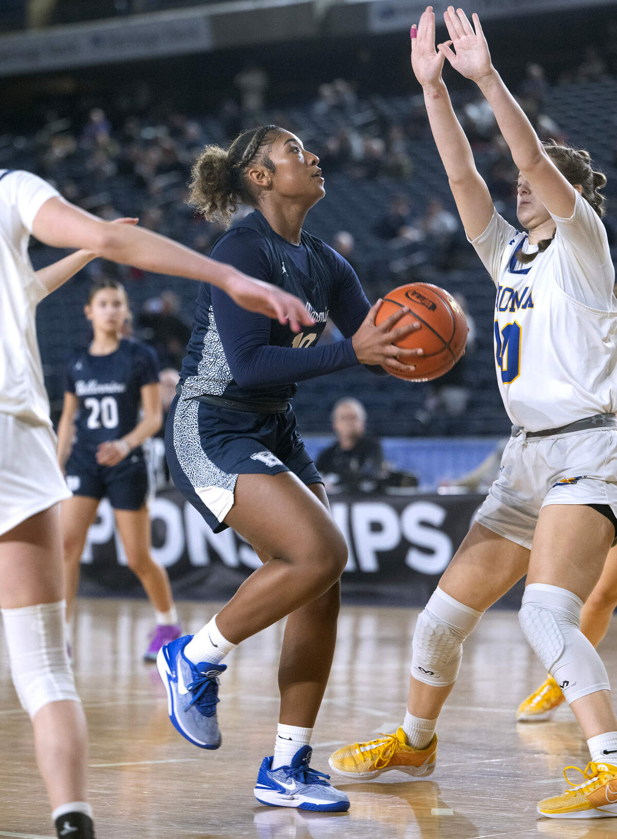 Bellarmine’s Kyla Frazier drives the lane against Tahoma defender Adalynn Busch during Wednesday morning’s opening-round game of the 4A girls state basketball tournament in the TacomaDome in Tacoma, Washington, on Wednesday, Feb. 28, 2024. Tahoma won the game, 53-38.
