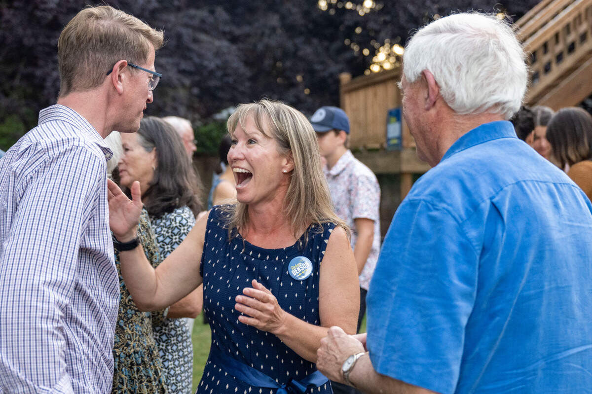 Democrat Robyn Denson (center) celebrates with U.S. Rep. Derek Kilmer, D-Wash. (left), after primary results were announced at an election party in Gig Harbor, Wash. on Tuesday, Aug. 2, 2022. Initial results on Tuesday evening had Denson capturing nearly 59-percent of the vote for the Pierce County Council, District 7 seat.