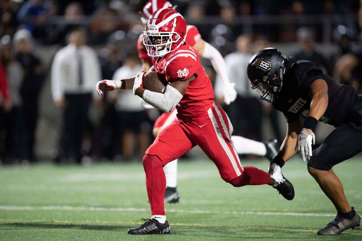 Mater Dei High School’s Raleek Brown (4), left, runs with the ball for a touchdown during a Trinity League game at Santa Ana Stadium in Santa Ana, Calif. on Saturday, Oct. 23, 2021.