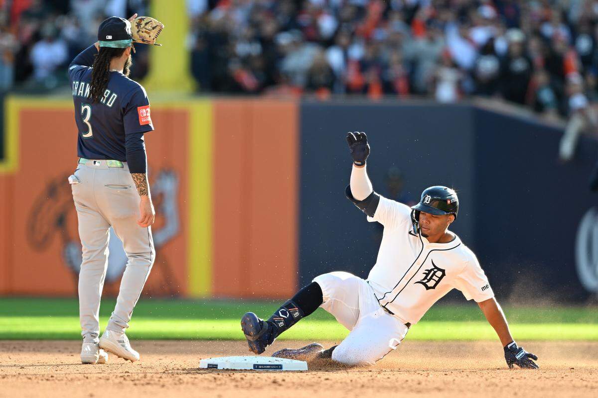 Oct 8, 2025; Detroit, Michigan, USA; Detroit Tigers right fielder Wenceel Pérez (46) slides into second base with a double as Seattle Mariners shortstop J.P. Crawford (3) looks on in the sixth inning during game four of the ALDS round for the 2025 MLB playoffs at Comerica Park. Mandatory Credit: Lon Horwedel-Imagn Images