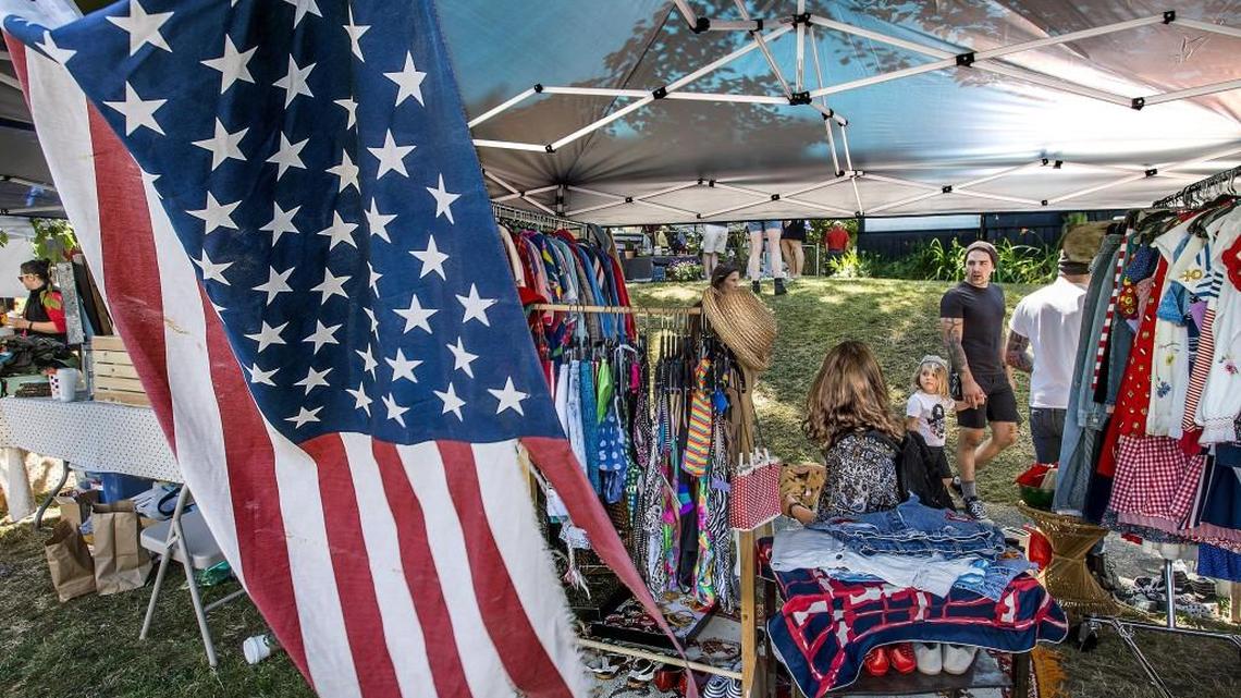 A well-worn American flag waves under the tent of Tacoma Flea Market vendor Rachele Piety’s Sassafratz shop that features hip vintage clothing and accessories. The new market in the Proctor District of Tacoma will be open second and fourth Saturdays through the summer.