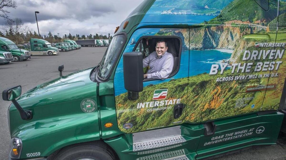Marc Rogers, head of the trucking company Interstate Distributors, has been named Business Leader of the Year by the UWT Milgard School of Business. After being chosen for the Milgard honor he posed in one of the company’s new 2016 Freightliner Cascadia Evolution trucks.