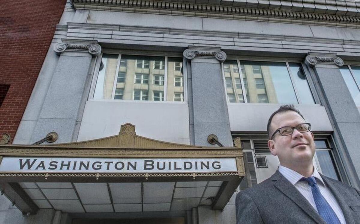 City Historian Reuben McKnight in front of the historic Washington Building in downtown Tacoma. The building could become an apartment high-rise under new ownership.