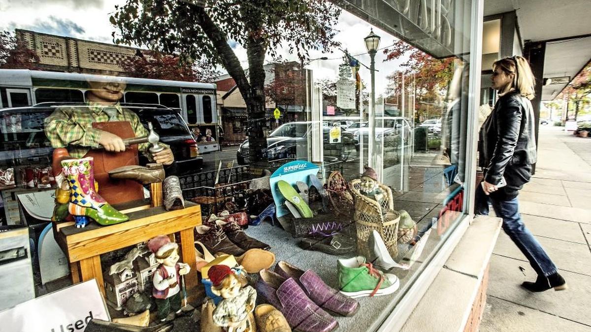 Lucy Grzeszczuk walks up to front of Proctor Shoe Repair last month to see if she could speak to someone about her shoes. Bentley Henry, Proctor Shoe Repair owner, said Tuesday volunteers have helped him call all customers with shoes and bags in for repair and talked to them about when their shoes will be ready. “We’re just working one day at a time,” he said.