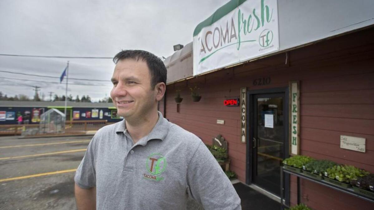 Tacoma Fresh owner William Manzanares stands in front of Tacoma Fresh and the smoke shop, back left, that he owns. Tacoma Fresh opened March 1. If the health food store is successful, Manzanares will expand the concept.