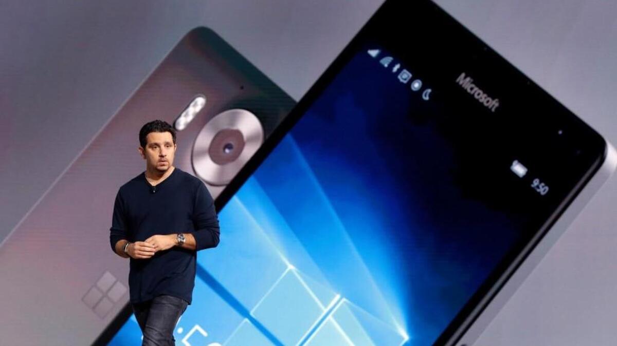 Panos Panay of Microsoft shows a Lumia 950 phone during a presentation in New York. The device will work with an optional dock and users can attach a regular monitor, keyboard and mouse and work with apps on the phone just like you would on a Windows 10 desktop.