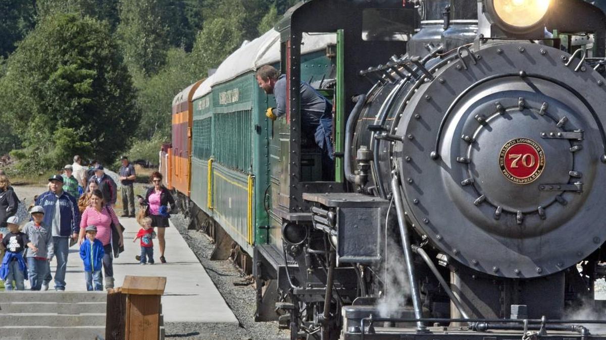 Engineer John Graddon watches as customers arrive at the Western Forest Products Museum in Mineral after riding the Mount Rainier Scenic Railroad on July 12, 2013.