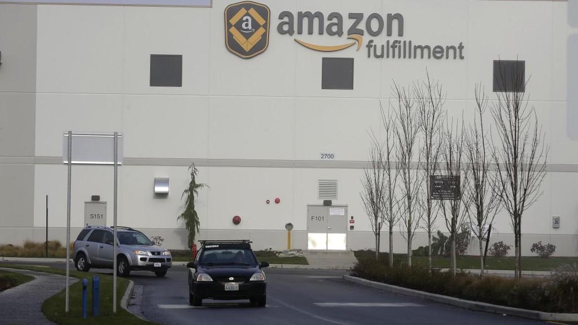 Cars drive away from Amazon.com’s fulfillment center in DuPont in 2015.