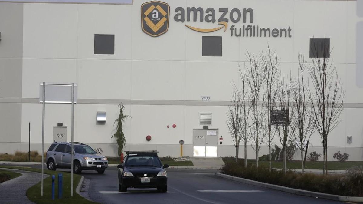 Cars drive away from Amazon.com's fulfillment center in DuPont in 2015. Amazon had to quickly form alternative routes for workers in the aftermath of the nearby fatal Amtrak derailment.