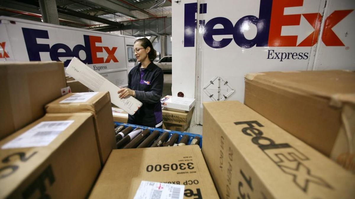 Rosa Santiago sorts packages before loading them onto delivery trucks at the FedEx Express Station in New York. FedEx centers in the Tacoma area are now hiring package handlers.