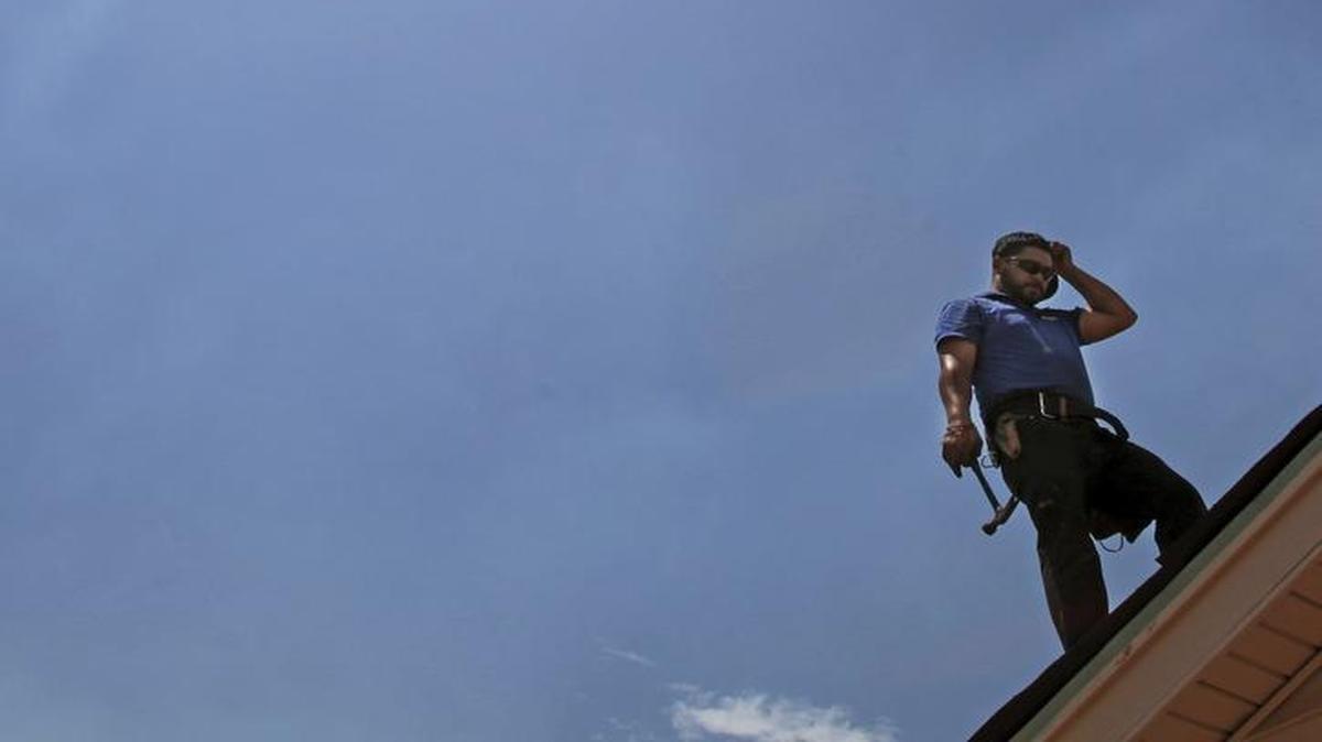 Julio Ruiz of J.R.R. Roofing paused in the heat while he and his crew removed old roofing on a house, as the temperature pushed 115 degrees in Tucson, Ariz. in June. Despite sweltering summers, Tucson’s total days with sun pushed the city to the top of Zumper’s list of best places to retire.