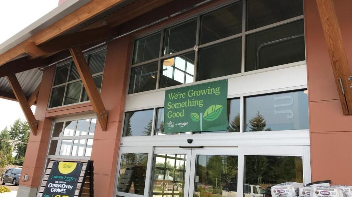 A Whole Foods/Amazon banner at the University Place store. The banner appeared after Amazon formally took acquisition of the chain last year.