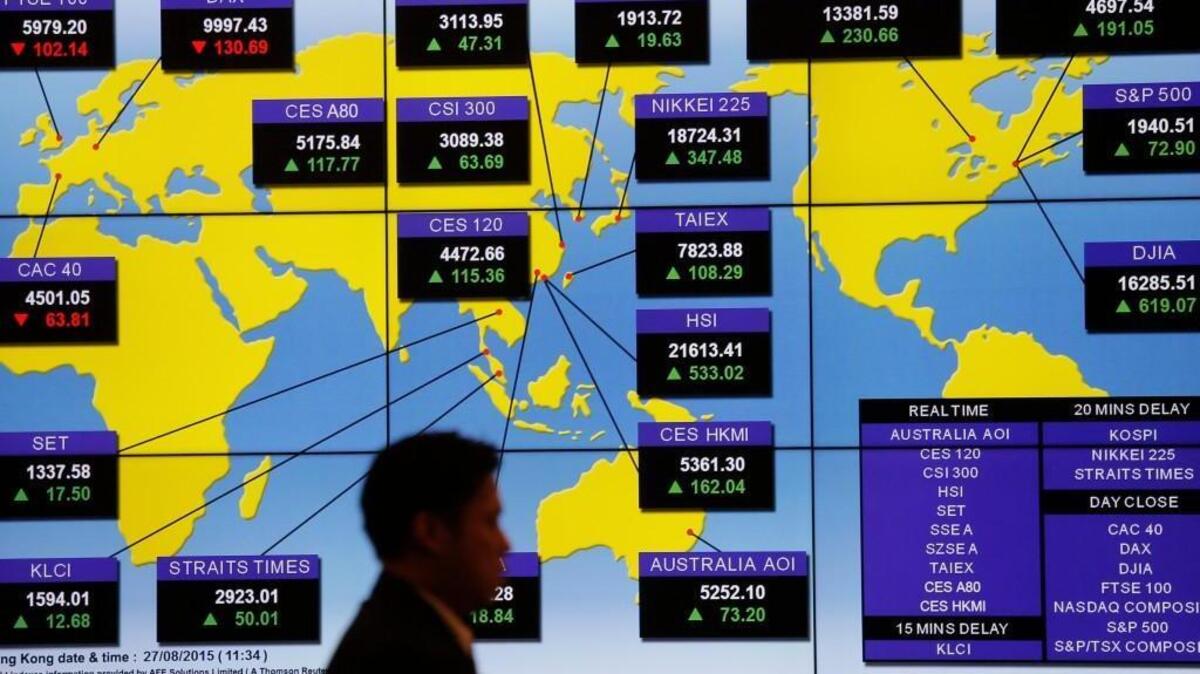 
A bank's electronic board shows the share index around the world at Hong Kong Stock Exchange last month. Investors have withdrawn billions of dollars from emerging-market stocks this year at a record pace, as a slowdown in China has hammered companies that supply raw materials.
