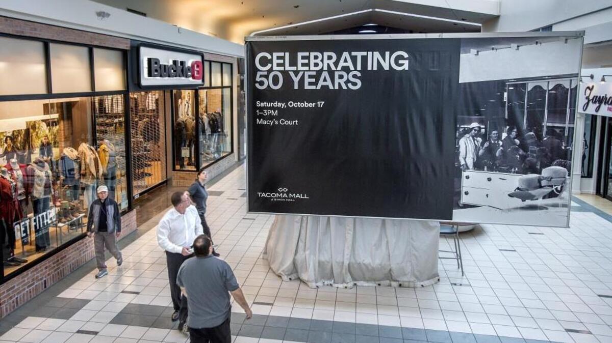 As early morning mall walkers roamed and before retail stores opened, Tacoma Mall’s Brian Garcia and Tom Walchli were hanging a banner announcing a celebration of the 50th anniversary of the Tacoma Mall in 2015. On Friday, the mall announced that Dick’s Sporting Goods will open a store in the space now occupied by Forever 21, and Forever 21 will likely move to a new and smaller location elsewhere at the facility.