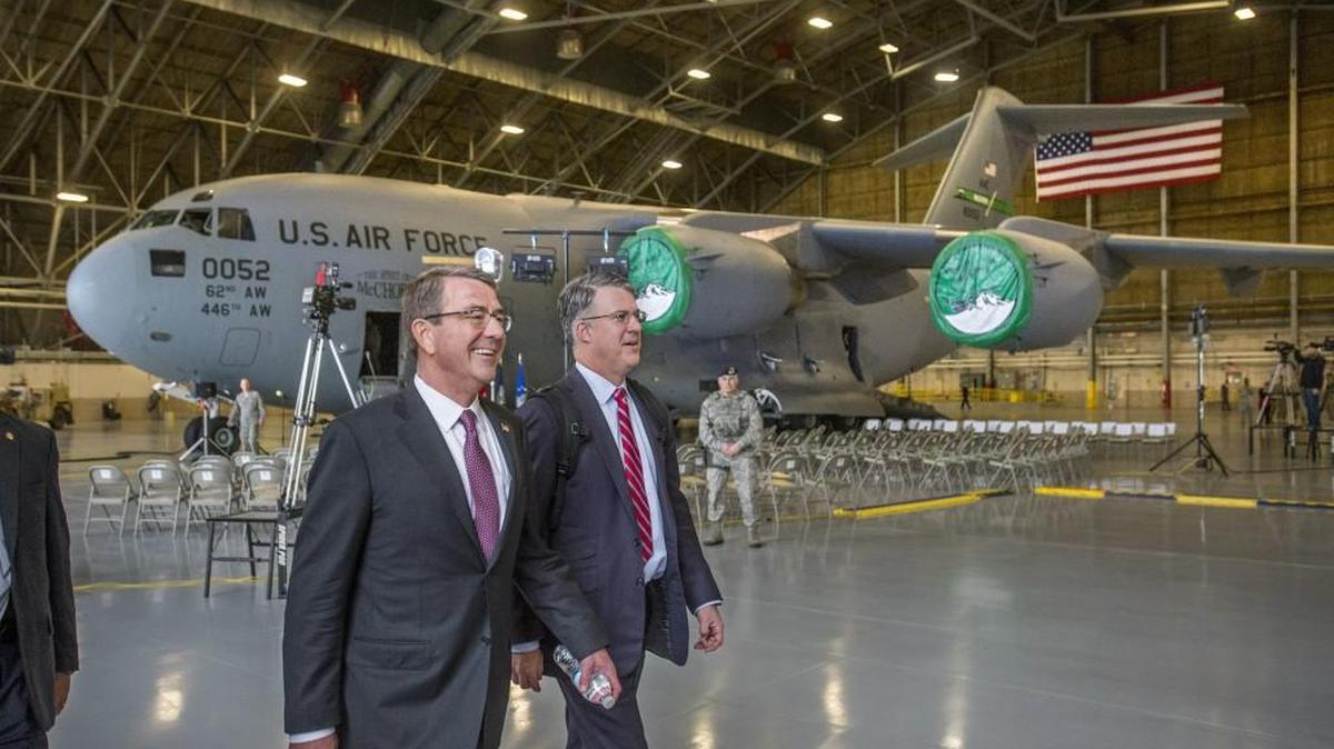 Secretary of Defense Ashton Carter (left) walks past a C-17 Globemaster transport plane during a visit to Joint Base Lewis-McChord in March. JBLM topped the Economic Development Board for Tacoma-Pierce County’s 2016 major employers list.