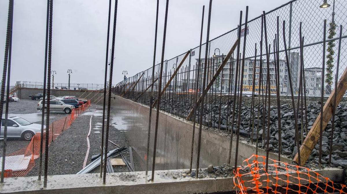 A retaining wall is the only portion of the planned Silver Cloud Hotel that has been completed at the Point Ruston waterfront development. The complex at rear includes The Century Apartments and Condominiums as well as restaurants and other businesses.