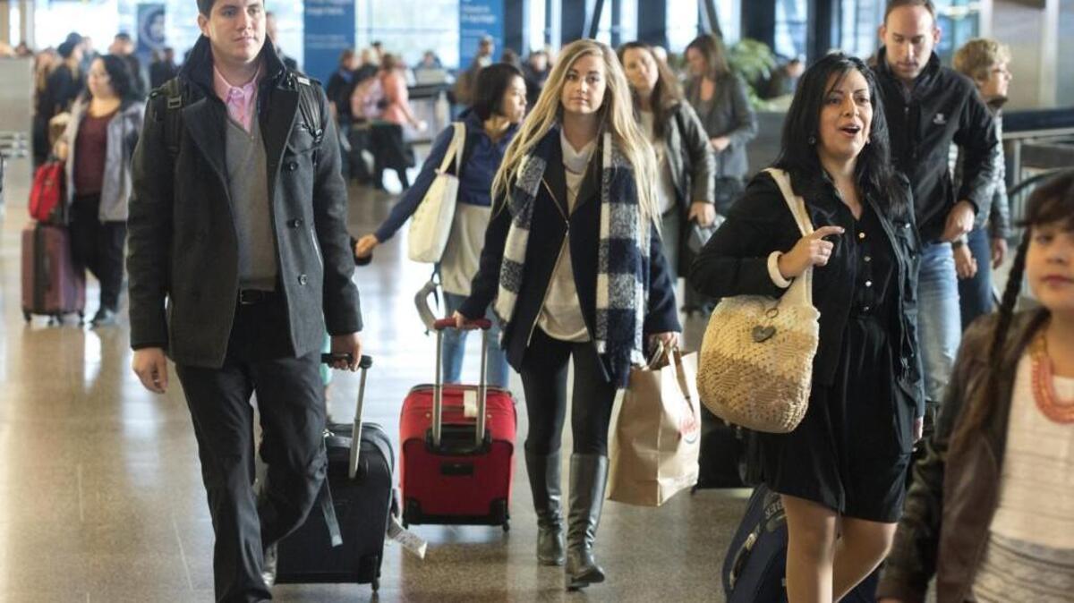 Travelers move through the ticketing area at Seattle-Tacoma International Airport on Nov. 21. Airport officials warn of a busy Presidents Day weekend at the airport.