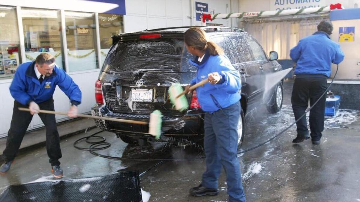 Brown Bear Car Wash employees wash an SUV in Bellevue in 2003. Brown Bear is giving away free car washes at all tunnel wash locations Thursday to mark its 60th birthday. There are five participating locations in Pierce County.