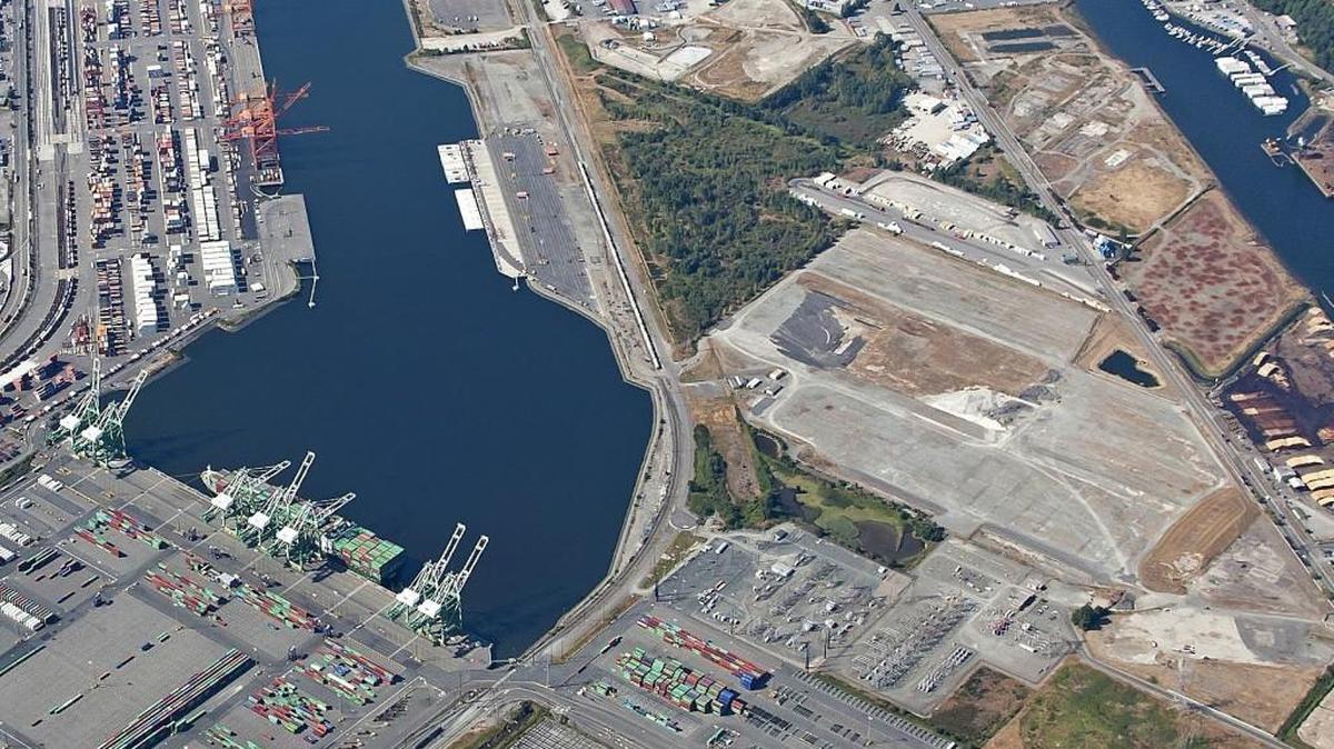 Northwest Innovation Works signed a 30-year lease with the Port of Tacoma in 2014 to build a proposed 125-acre methanol production facility on the former Kaiser Aluminum smelter property – the cleared area at right in this aerial photo. The plant would convert natural gas delivered by pipeline into methanol and the liquid would travel by tanker ships up the Blair Waterway and across the Pacific Ocean to China.