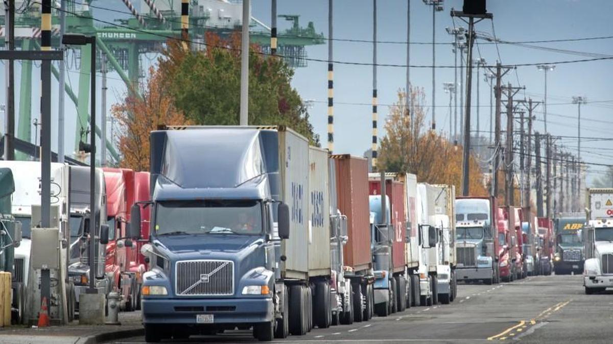 Truckers park in 2014 along Port of Tacoma Road while waiting to unload their cargo in Tacoma. Delegates to a meeting of the International Longshore and Warehouse Union, representing ports from Bellingham to San Diego, have approved a proposal to ask members about extending the current five-year agreement with the Pacific Maritime Association for another three years, from 2019 to 2022. The ILWU didn’t publicly release a timetable for the vote, but reports suggest ballots are in the mail.