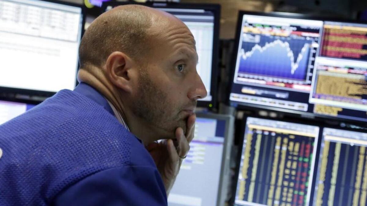 
Specialist Meric Greenbaum works at his post on the floor of the New York Stock Exchange, Friday, Aug. 28, 2015.
