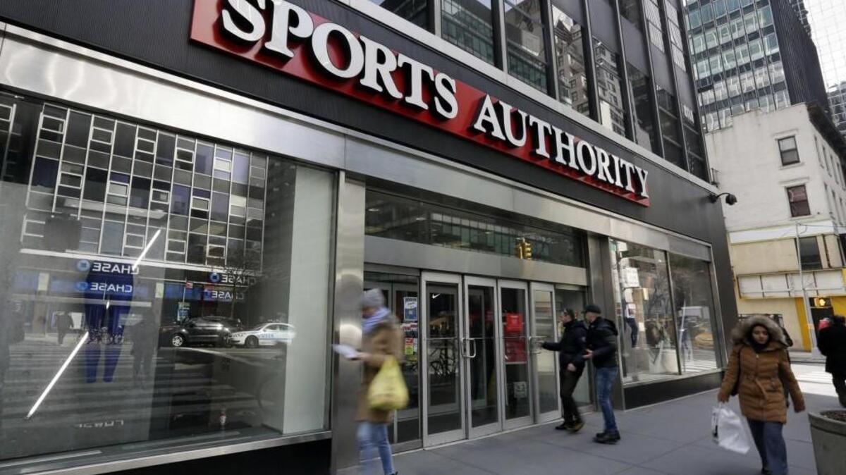 People enter a Sports Authority store, in New York earlier this year. Sports Authority is filing for Chapter 11 bankruptcy protection.