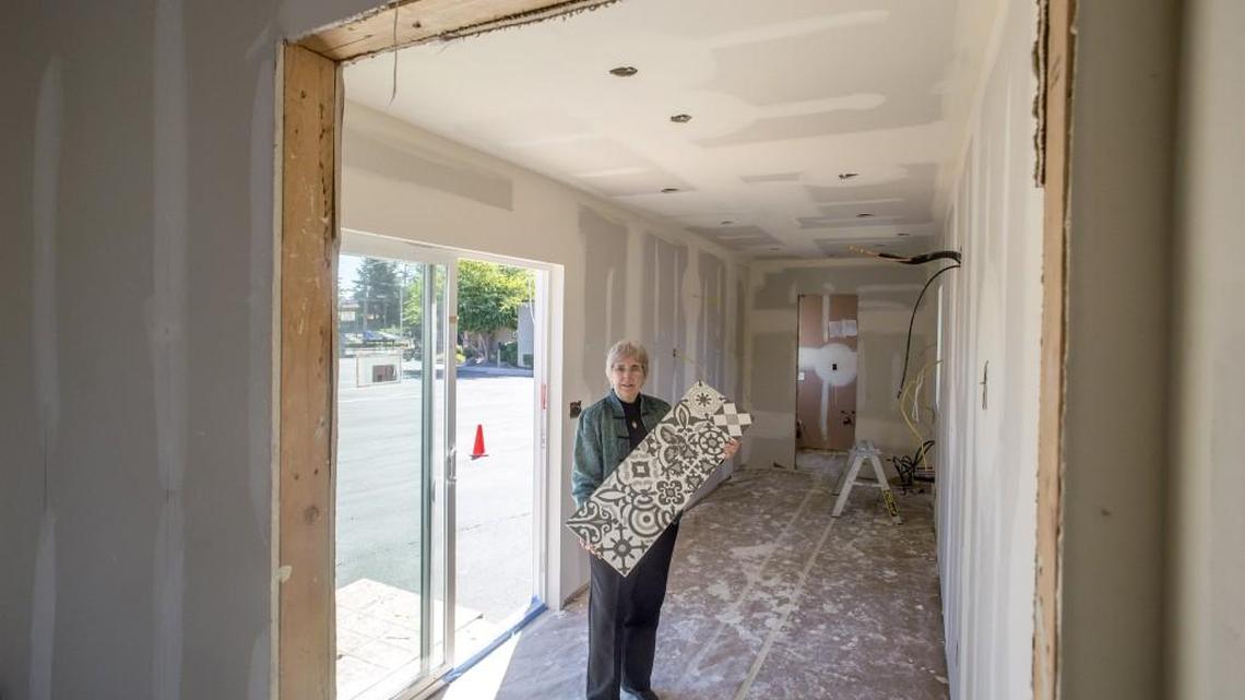 Karen Hirschman of the Washington State chapter of American Society of Interior Designers shows some tile that will be used as kitchen backsplash and in the bathroom of this house made from a steel shipping container.