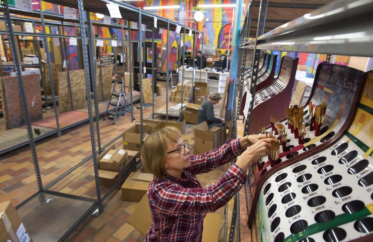 Sales associate Judy Buskirk, who was also an outreach coordinator for area school art programs, stocks watercolor and acrylic brushes at Artist & Craftsman Supply in Tacoma on Oct. 26., 2016.