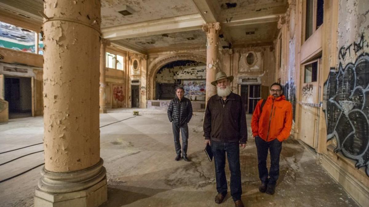 Mike McMenamin, co-owner of McMenamins, center, architect George Signori, left, and Chris Longinetti, CFO of McMenamin’s, visit the auditorium of the old Elks Lodge in downtown Tacoma in November.