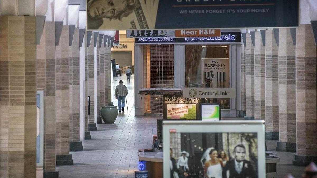 
A elderly mall walker passes through a classic colonnade, a series of concrete columns that have been tiled over, in front the entrance to Macy's at Tacoma Mall on Thursday, Oct. 1, 2015. 
