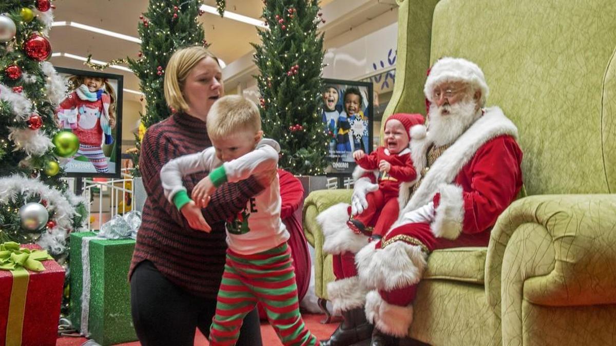 Rose Olson of Lakewood attempts to get a photo of her sons Silas (left) and Gage Olson with Santa at the Tacoma Mall, November 22, 2016.