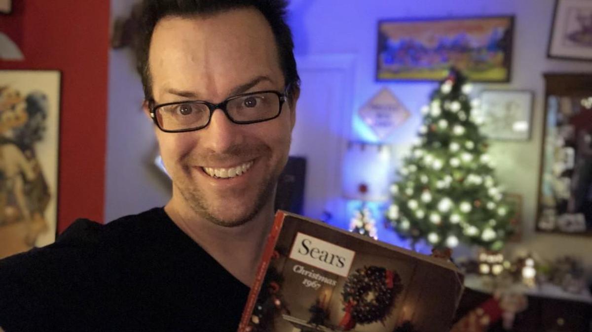 Jason Liebig with one of his catalogs, a 1967 Sears Wish Book at home in Astoria, Queens, NY.