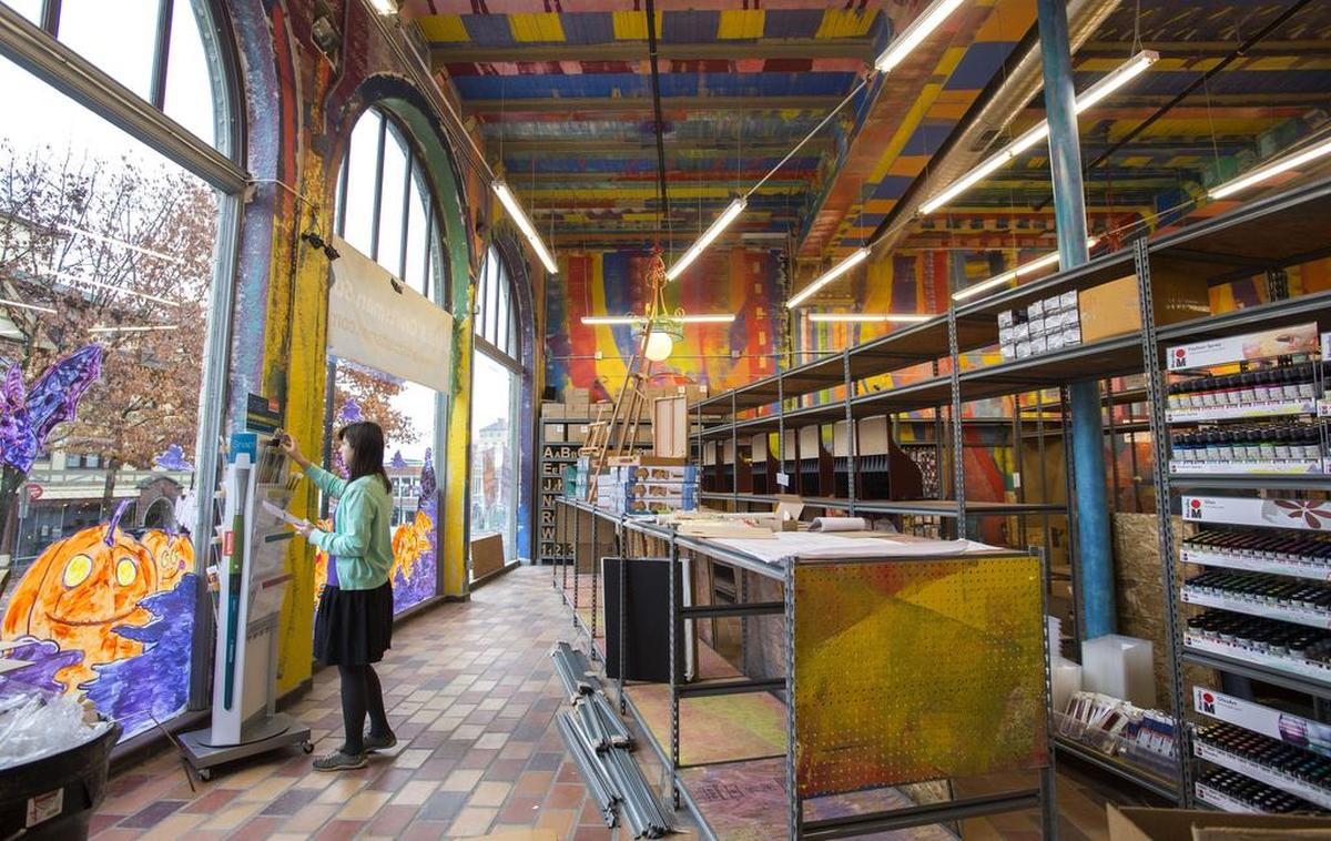 The cavernous 1928 Wagner Motors building in downtown Tacoma is where Artist & Craftsman Supply is located. Sales associates, including Masha Fikhman, were busy stocking displays for the Nov. 25, 2016 opening.
