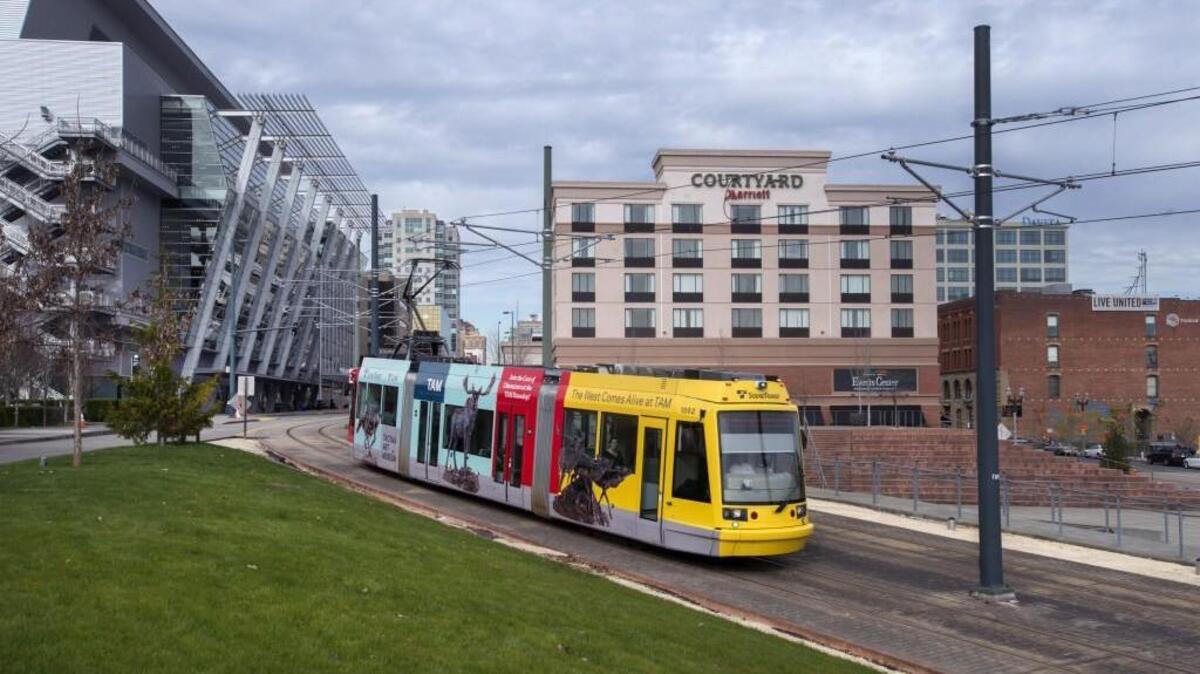 A Link light rail car rolls past the Greater Tacoma Convention & Trade Center. Website MeetingSource.com lists Tacoma among the top four destinations for small conventions.