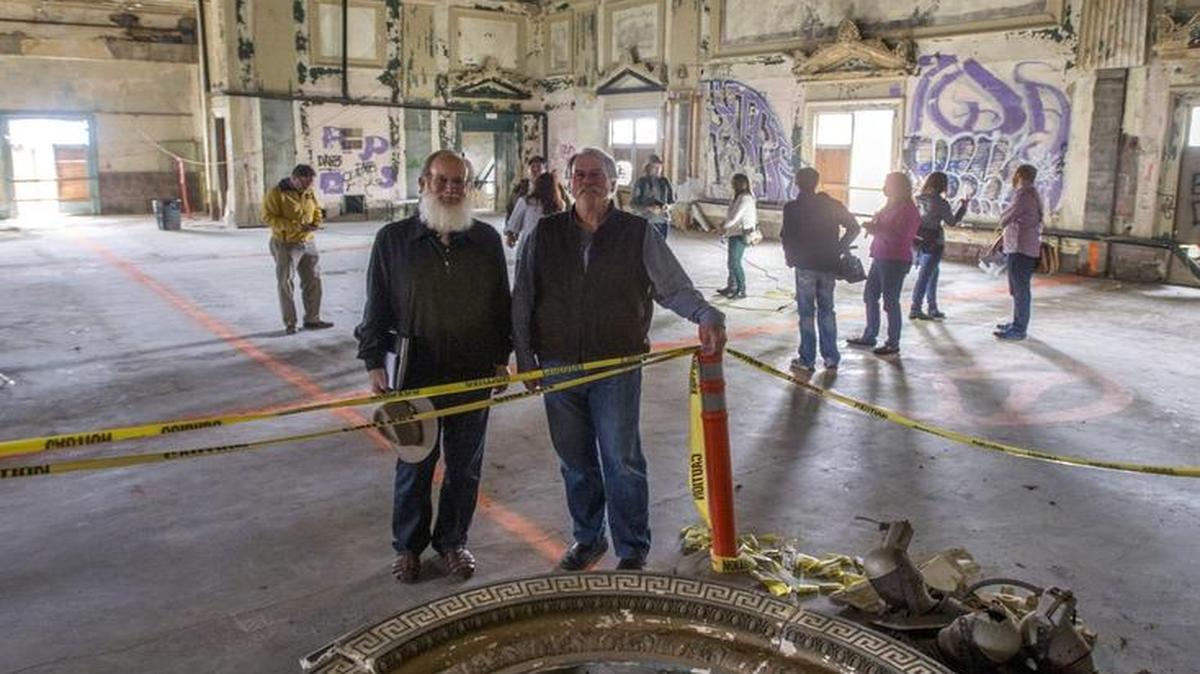 From left, Mike and Brian McMenamin stand in the ballroom of the old Tacoma Elks Lodge. When they redevelop the abandoned building, it will have hotel rooms and a bar.