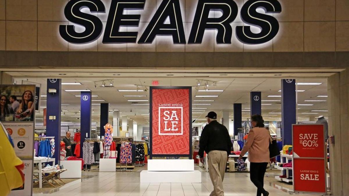 Shoppers walk into a Sears store in Pittsburgh earlier this year. After years of mounting losses, the parent company of Sears and Kmart says there is “substantial doubt” about its financial viability.
