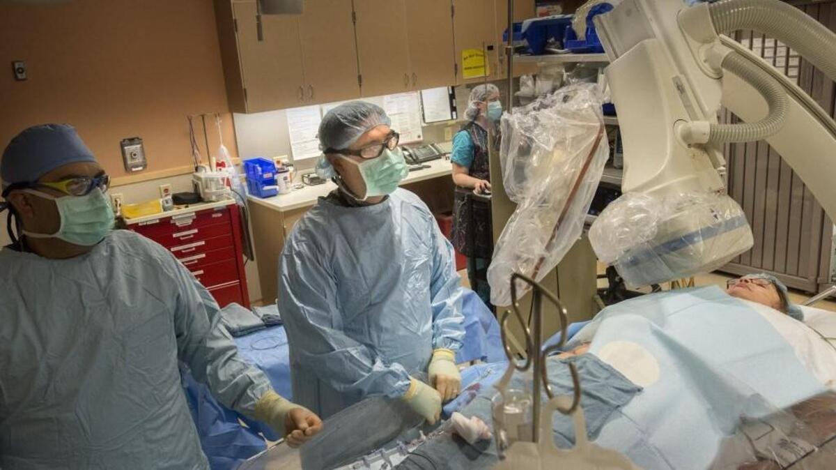 Dr. Daniel Guerra, center, watches the monitors during a procedure at Pulse Heart Institute to check on a bad aortic valve on Wednesday. Pulse started in May and is a joint venture between MultiCare Health System and Cardiac Study Center.
