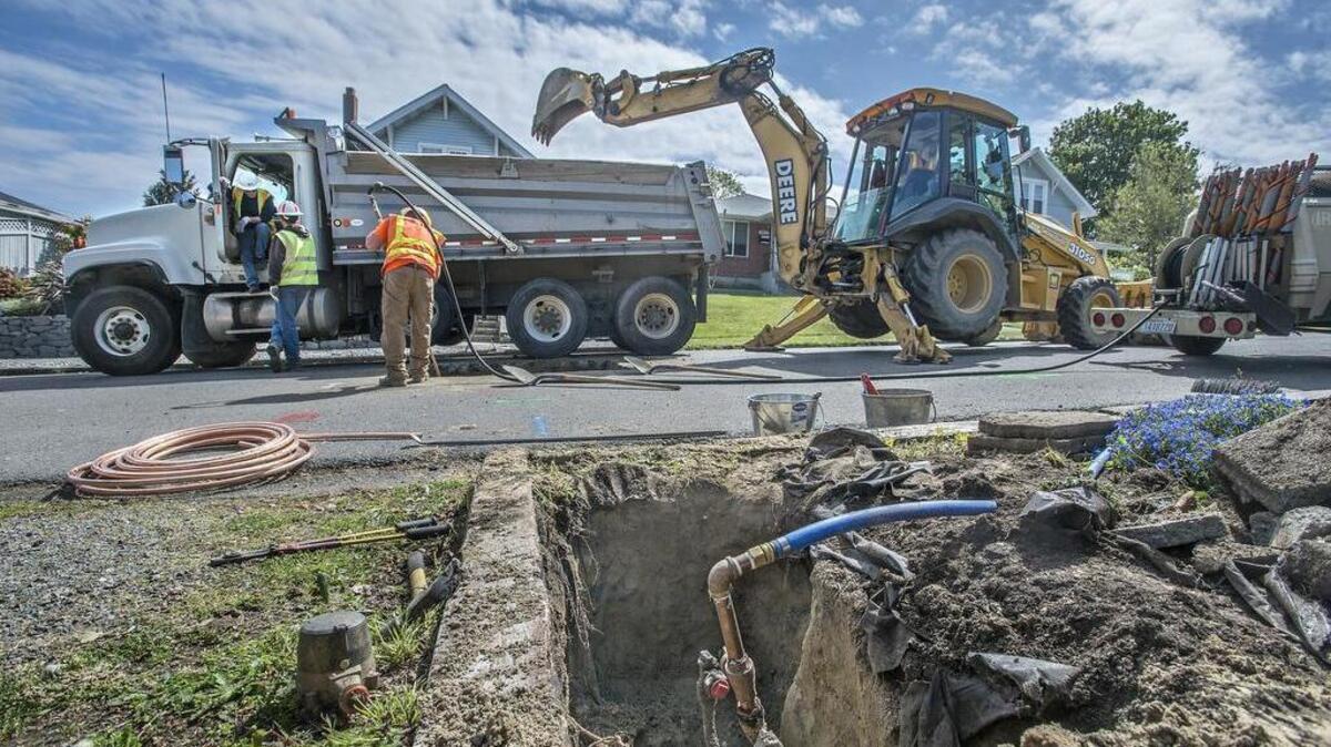 Workers from Tacoma Water replace a galvanized pipe for water service to a home in North Tacoma with copper pipe Thursday. No lead gooseneck fitting was found.