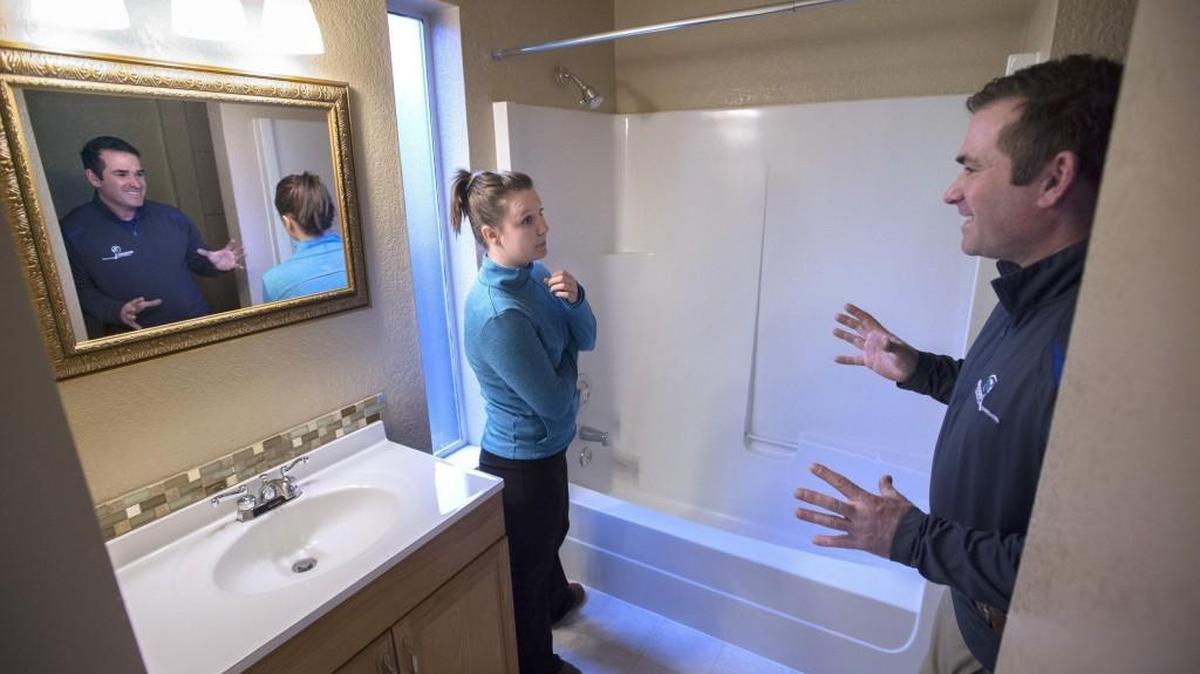 First-time homebuyer Nicole Boatright, an assistant nutrition program director with the Clover Park School District, talks with home inspector Bill Ryan of Boggs Inspection Service during an inspection of the two-bedroom home in Tumwater earlier this year. CoreLogic reports that Washington home prices are rising at a faster pace than other states.