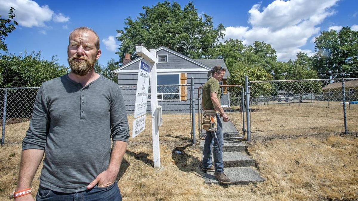 
David Gintz, a redeveloper who buys up bank-owned and uninhabitable properties and rehabs them for sale, has sold the house at 3301 S. Cushman three times but thus far hasn't closed in 120 days due to underwriting issues. He and T-Town Builders partner James Staedler, center checked on the long-vacant house July 23. 
