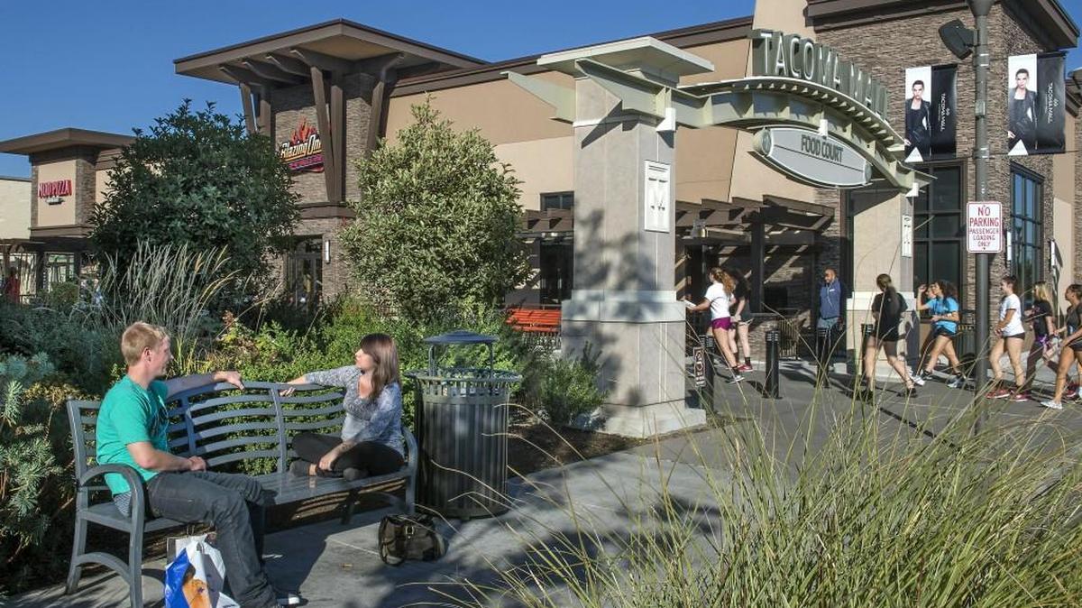 
Benjamin Flack, left, and Danielle Lance enjoy the park-like setting outside the Tacoma Mall.
