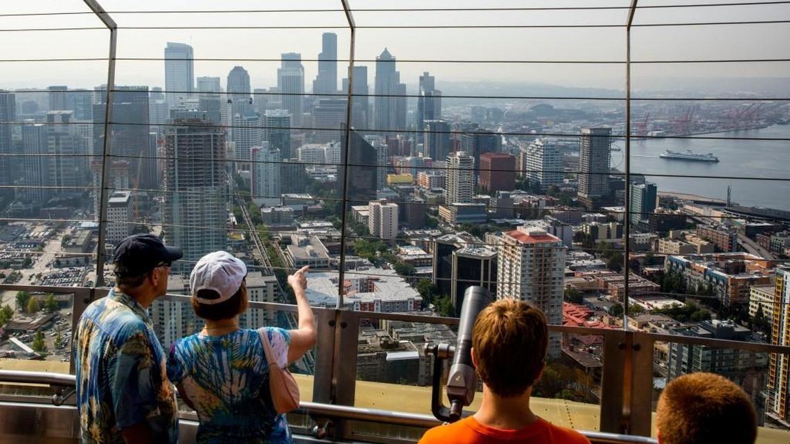 Visitors view the Seattle skyline from the top of the Space Needle. New rankings on apartment rental increases and overall affordability illustrate the ripple effect Seattle is having on Tacoma’s economy.