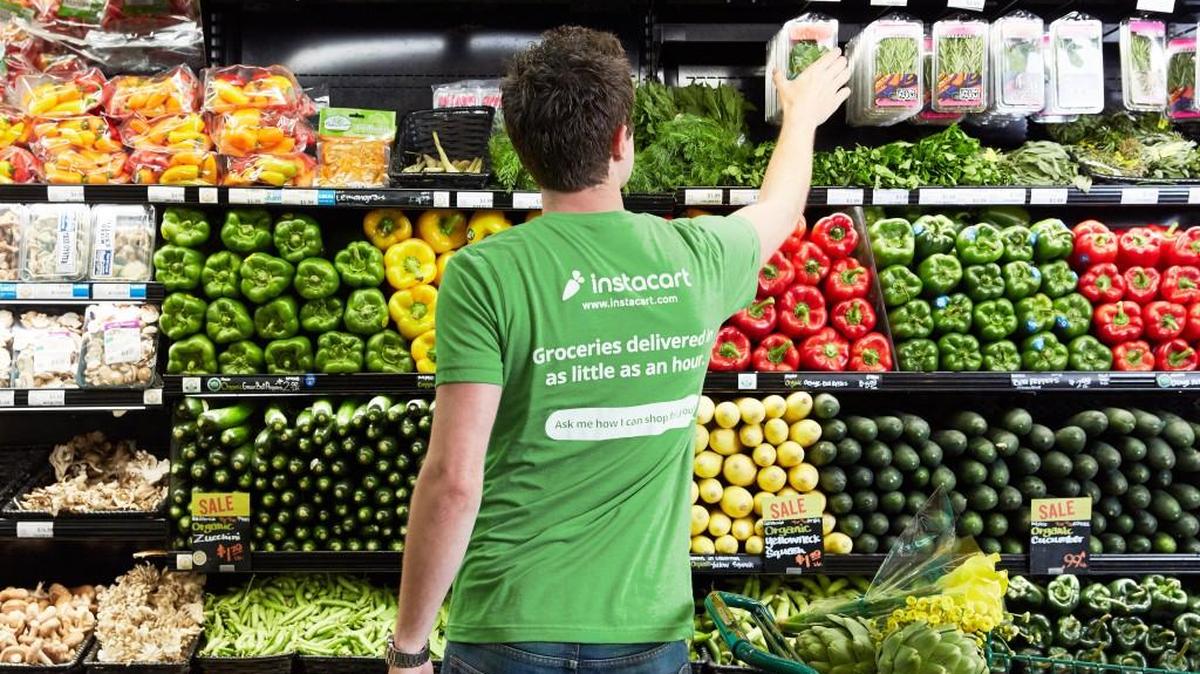 An Instacart “shopper” fills an order at the market of a customer’s choice. The online delivery service is facing criticism for its new pay structure for its shoppers.