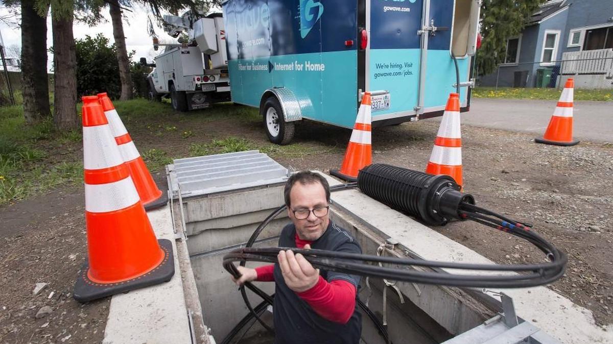 Wave employee Randy Salentine removes a splice case containing fiber optic cable out of a vault at a hub point in Auburn last month. The regional broadband provider is ramping up service to South Hill and other Pierce County communities.