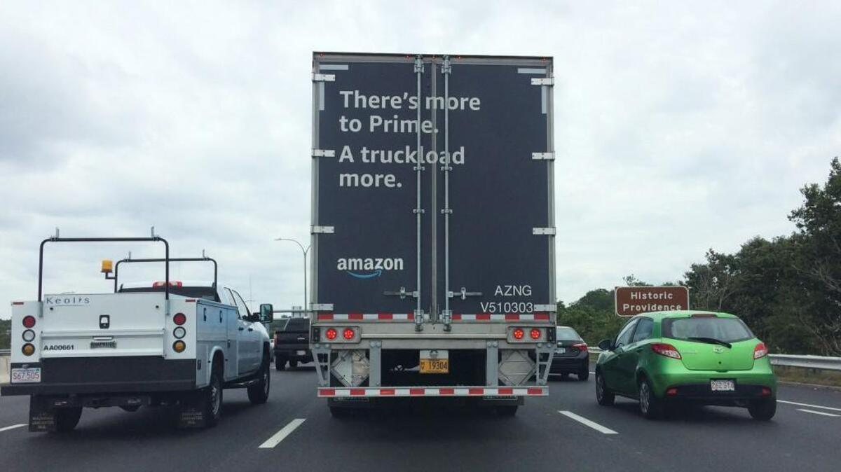 A truck carrying packages for Amazon moves through traffic in Providence, R.I.