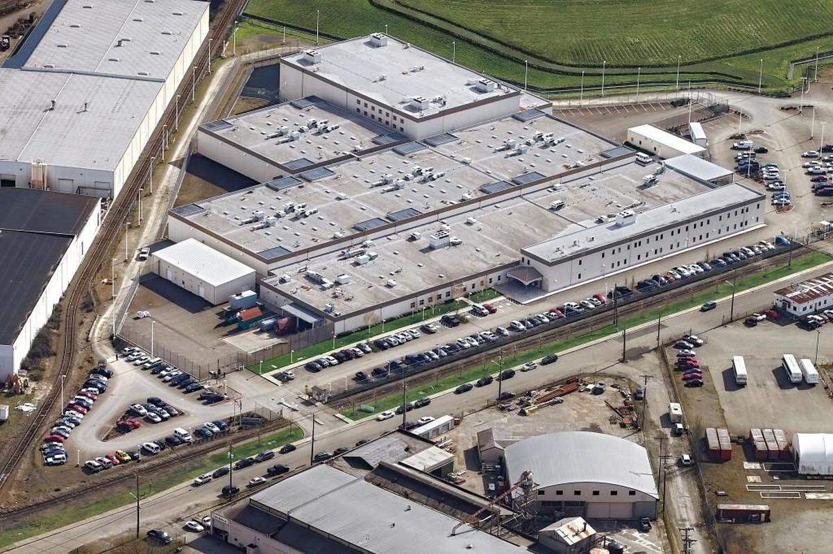 The Northwest ICE Processing Center, formerly known as the Northwest Detention Center, is a privately owned and operated immigration detention center on the Tacoma Tideflats. It opened in 2004 with a 500-bed capacity. It has since expanded capacity three times into a facility with 1,575 beds, making it one of the largest immigration detention centers in the United States. Aerial photo taken in 2012.